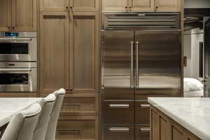 Kitchen with stainless steel appliances and light countertops