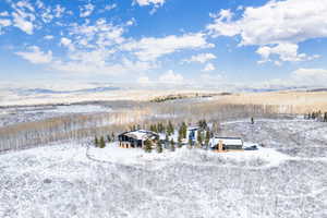 Snowy aerial view featuring a mountain view