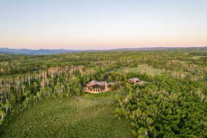 View of subject property with a heavily wooded area