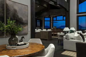 Dining space featuring dark wood-type flooring and a towering ceiling