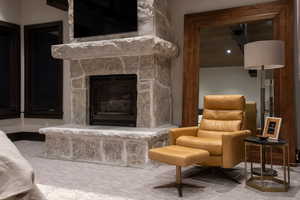 Carpeted living area with a fireplace