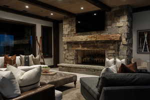 Living room with a wooden ceiling with exposed beams, a fireplace, carpet, and recessed lighting