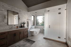 Bathroom featuring vanity, a soaking tub, vaulted ceiling, wooden ceiling, and tile walls