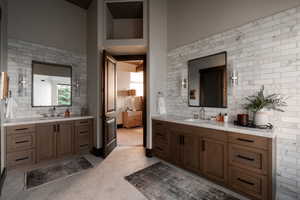 Full bath with backsplash and two vanities