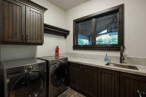 Laundry area featuring cabinet space, washer and dryer, and stone finish floors