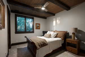 Bedroom featuring a wooden ceiling with exposed beams, carpet, and a ceiling fan