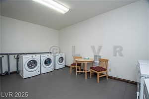 Laundry area with washer and dryer and baseboards