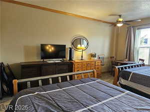 Bedroom featuring a textured ceiling and wood finished floors