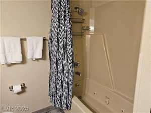 Bathroom featuring shower / bath combination with curtain