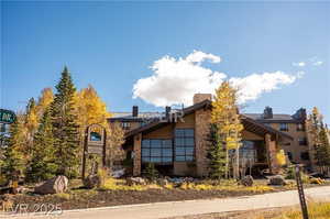 View of front facade with stucco siding and a chimney
