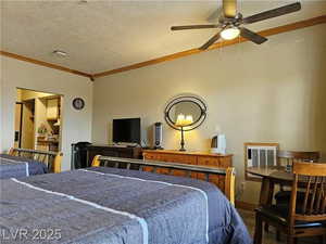 Bedroom with wood finished floors, crown molding, and a textured ceiling