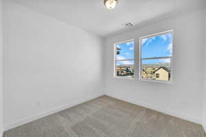 Unfurnished room featuring carpet and baseboards