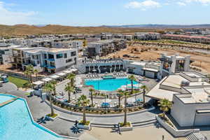 Aerial perspective of suburban area with a pool area and a mountain backdrop