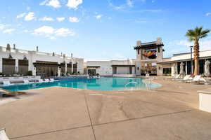 Community pool with a patio