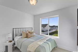 Bedroom featuring carpet flooring and baseboards