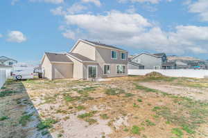 Back of property featuring stucco siding