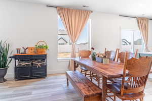 Dining space featuring light wood-style floors and baseboards