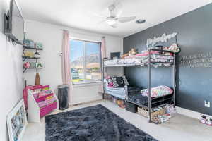 Bedroom featuring ceiling fan and a mountain view