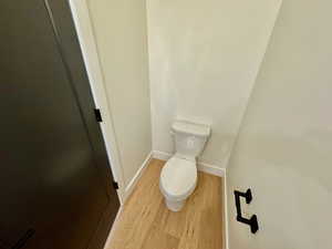 Bathroom featuring toilet and wood finished floors