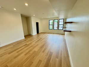 Unfurnished living room featuring light wood-style flooring, recessed lighting, and a textured ceiling