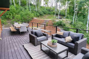Wooden deck with outdoor dining space and outdoor lounge area