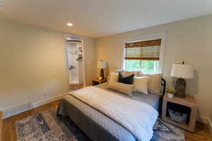 Bedroom with wood finished floors and recessed lighting
