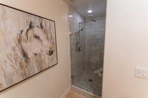 Full bathroom featuring a stall shower and recessed lighting