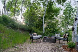 View of yard with an outdoor fire pit