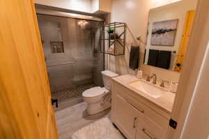 Bathroom featuring a stall shower and vanity