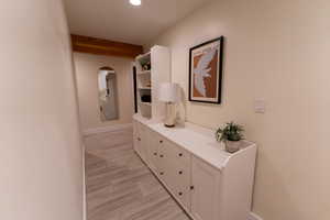 Hall with recessed lighting and beam ceiling