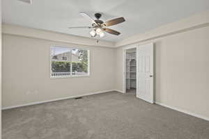 Master bedroom featuring carpet, ceiling fan, and a closet (angle 1)
