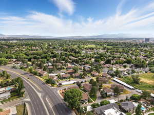 Aerial overview of property's location with mountains and nearby suburban area