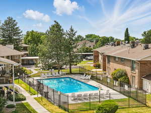Community pool with a residential view