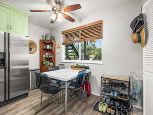 Dining area with light wood-type flooring and a ceiling fan