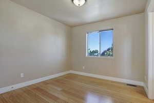 Empty room featuring light wood-style flooring and baseboards