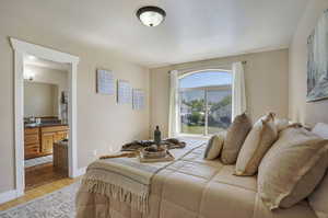 Bedroom with light wood-style floors and baseboards
