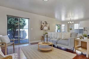 Living area featuring hardwood / wood-style flooring and a chandelier