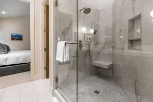 Bathroom with a stall shower, ensuite bathroom, tile patterned flooring, and recessed lighting
