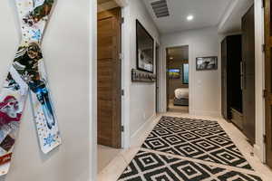 Hallway featuring light tile patterned flooring and recessed lighting
