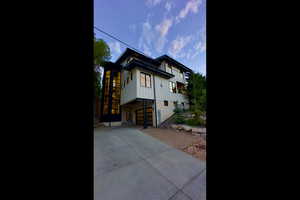 View of property exterior featuring driveway and an attached garage
