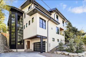 View of building exterior with a garage and driveway