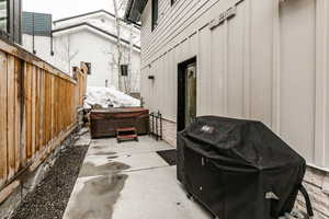 View of patio / terrace featuring a hot tub and grilling area