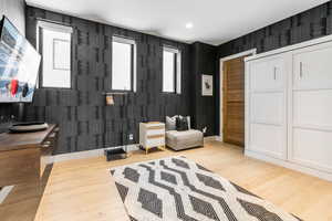 Living area with plenty of natural light, light wood-type flooring, and recessed lighting