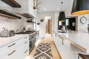 Kitchen with double oven range, open shelves, modern cabinets, tasteful backsplash, and recessed lighting