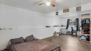 Bedroom featuring wood finished floors and a ceiling fan