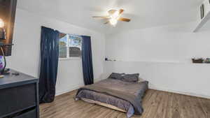 Bedroom featuring wood finished floors and a ceiling fan