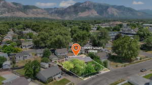 Aerial perspective of suburban area featuring property parcel outlined and mountains