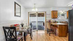 Dining space featuring light wood-style floors and a chandelier