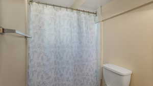 Full bathroom with curtained shower
