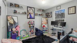 Office with wood finished floors and ceiling fan